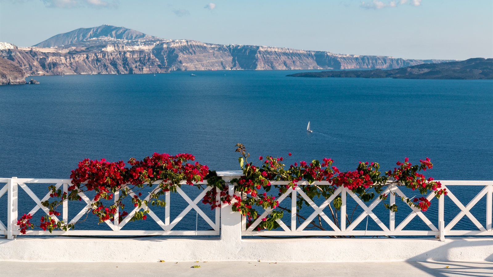White Aegean village above the sea at sunset